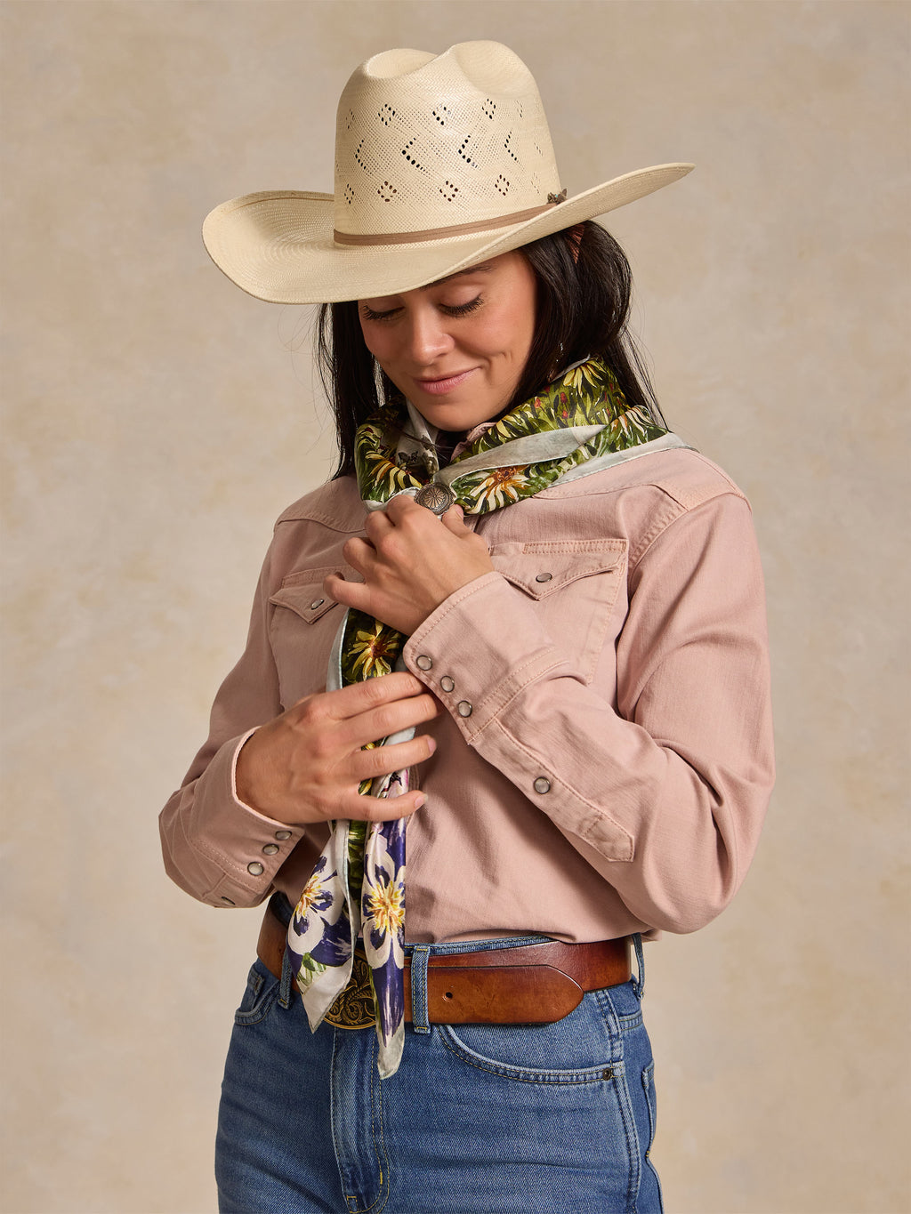 Wild rag scarf worn with pink shirt and hat; colorful cowboy-and-horse pattern neck tie.