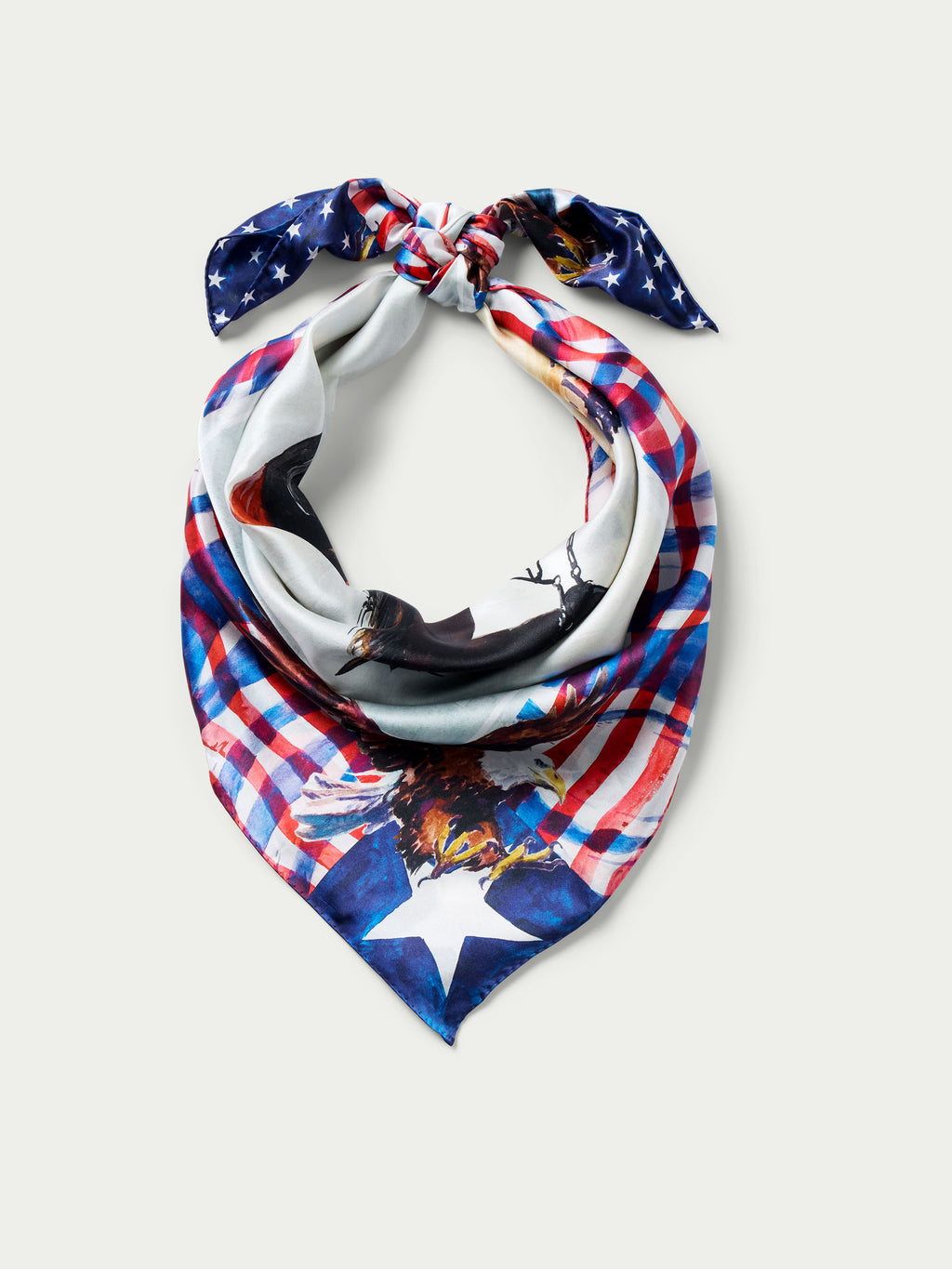 Wild rag scarf with knotted star-and-horse design in red, blue, and white plaid.