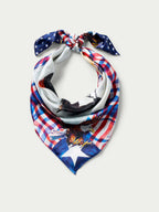Wild rag scarf with knotted star-and-horse design in red, blue, and white plaid.