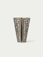 Paisley-patterned cone cup with two vertical motif panels in black on a cream base