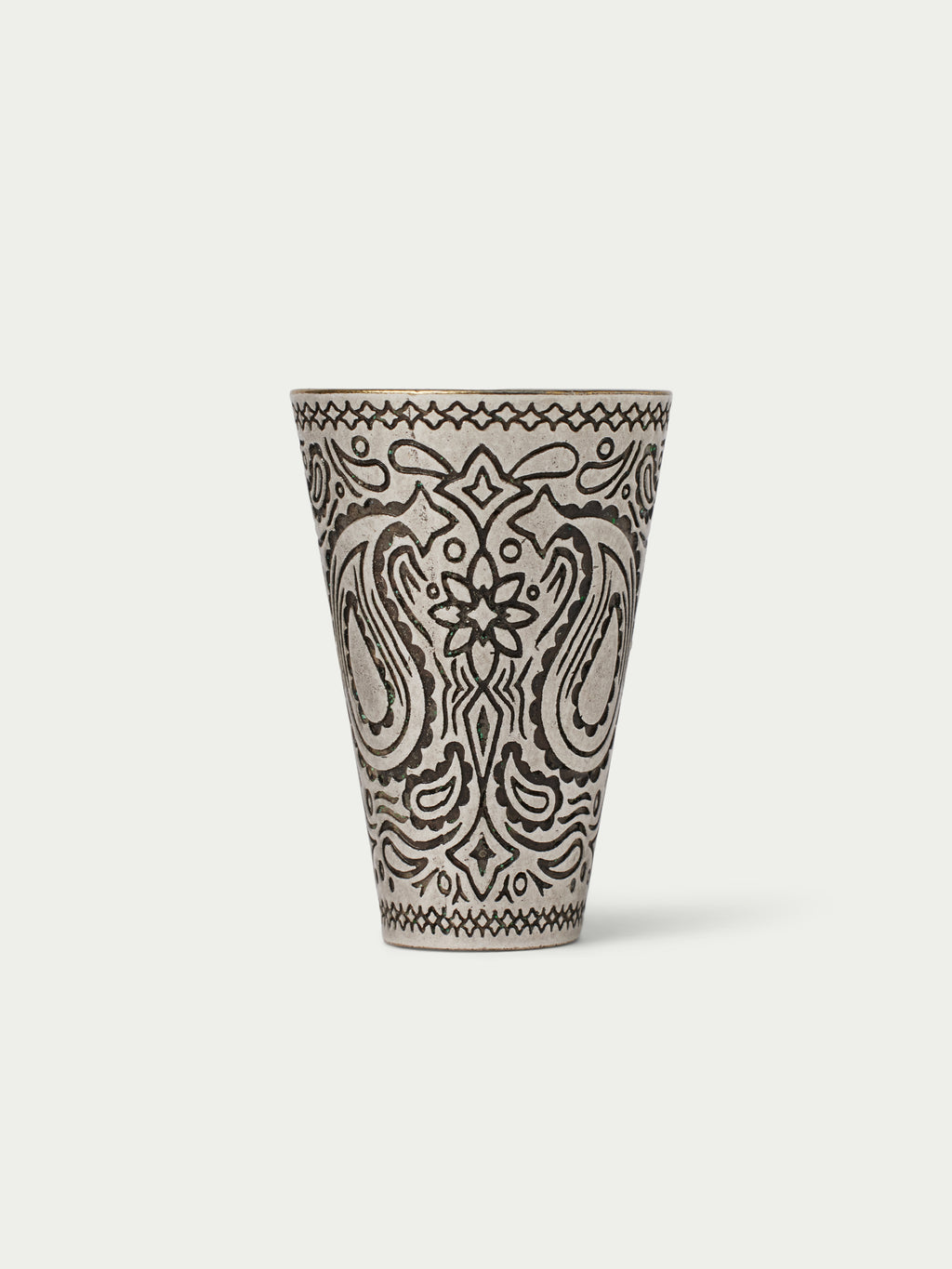 Paisley-patterned cone cup with black line art on a cream base, top rim visible