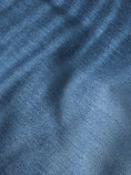 Blue denim fabric close-up showing twill texture