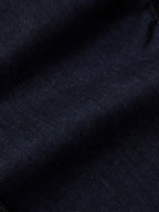 Dark rinse denim fabric texture close-up