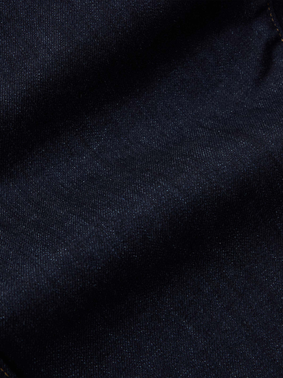 Dark rinse denim fabric texture close-up