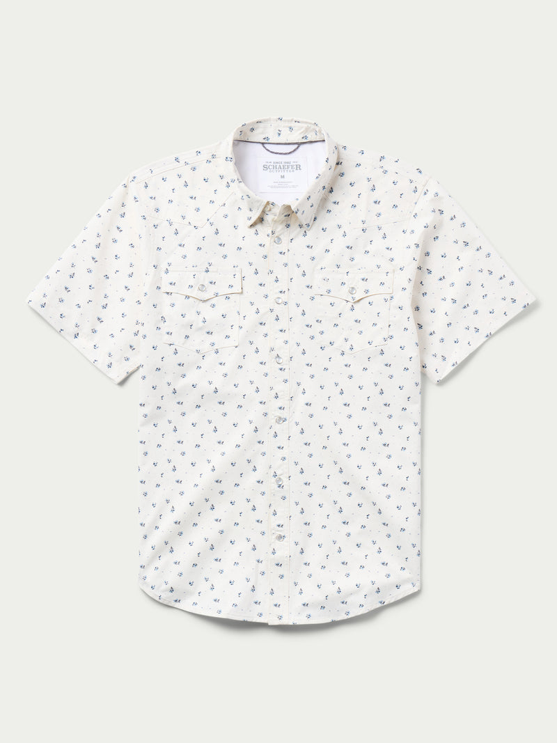 Short-sleeve pearl snap shirt in white with small blue floral pattern, chest pockets.