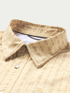 Short sleeve western shirt with pearl snap placket and pointed yoke; cream patterned.