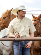 Light beige short-sleeve pearl snap western shirt with button pockets and chest snap placket
