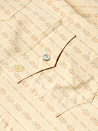 Detail of short sleeve pearl snap western shirt: metal snaps and decorative chest stitch.