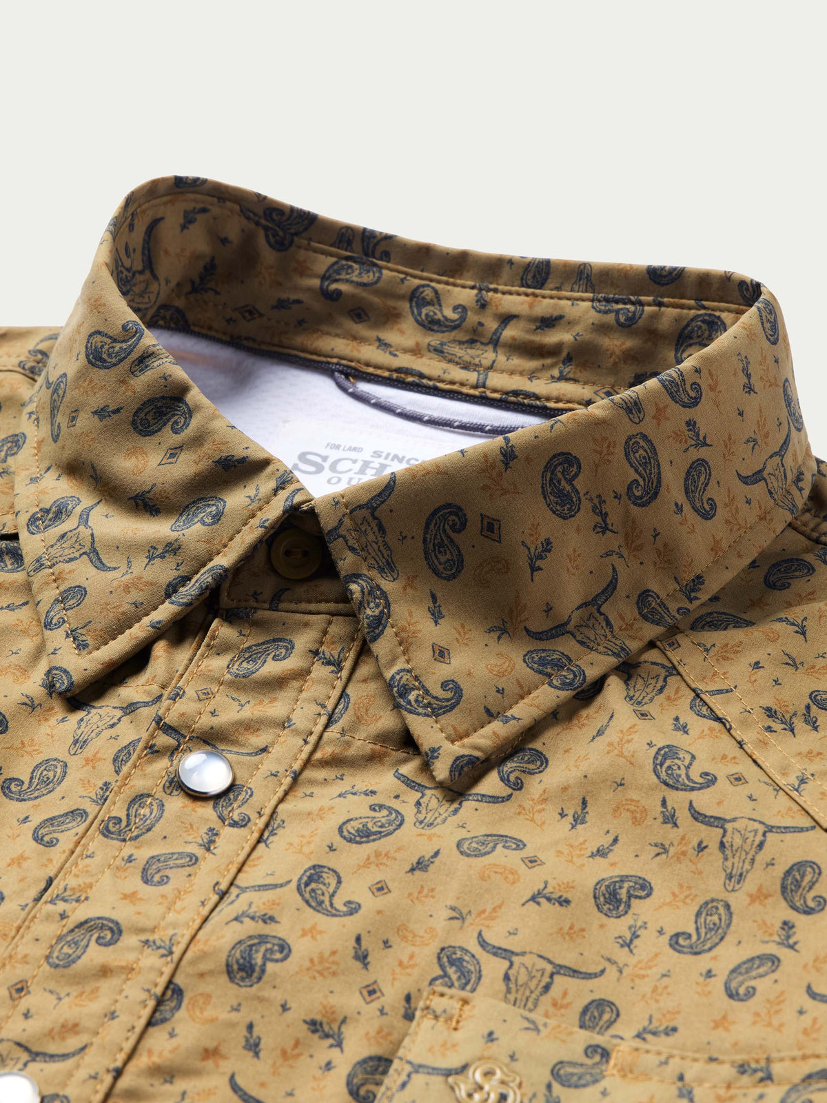 Short sleeve western shirt collar close-up with pearl snap placket and patterned fabric.