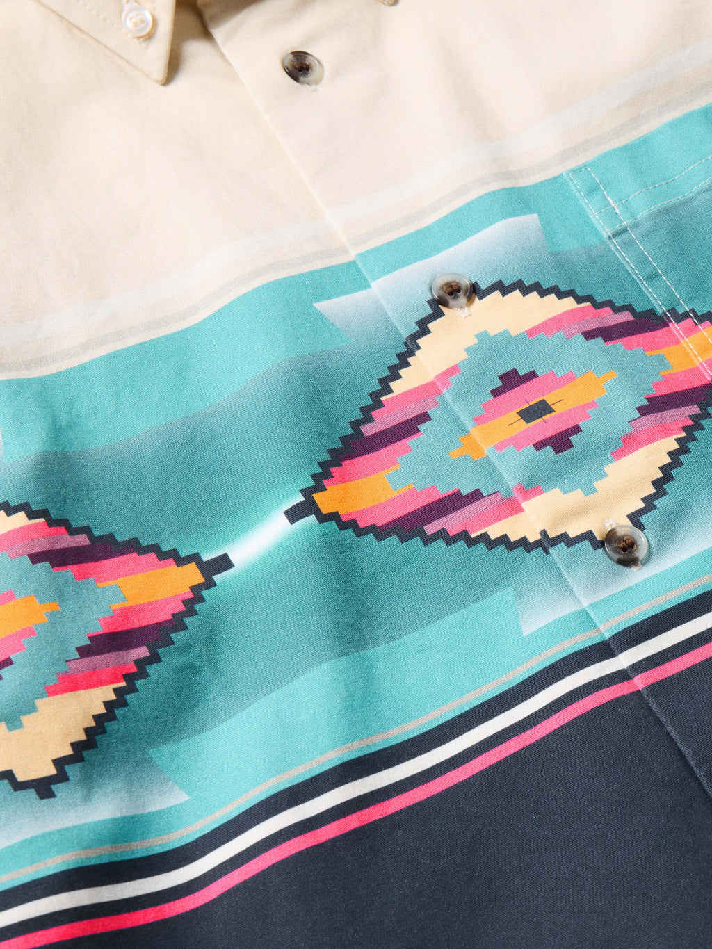 Button-down shirt front close-up with turquoise, pink, and orange diamond graphic panel