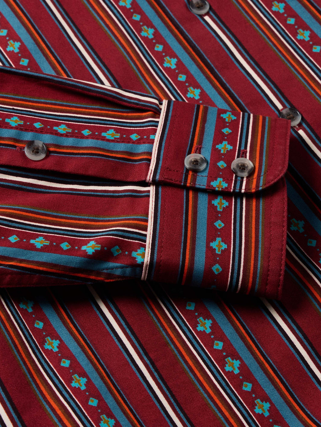 Striped button cuff and shoulder yoke with dark buttons on red multicolor shirt