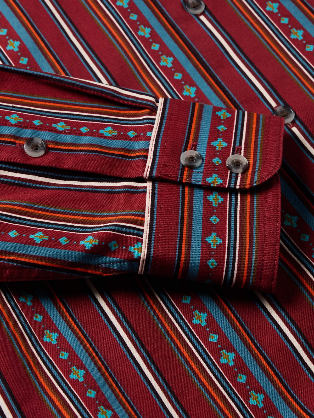 Striped button cuff and shoulder yoke with dark buttons on red multicolor shirt