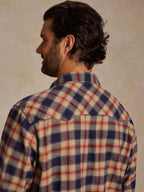 Plaid flannel button-down shirt, back view; long sleeves, navy and tan plaid.