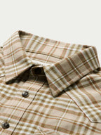 Tan plaid flannel shirt collar and button placket with dark buttons