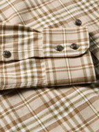 Tan plaid flannel button-down with two chest pockets and dark buttons