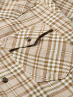 Tan plaid flannel shirt with chest pocket and dark front button