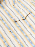 Cotton snap shirt yoke and placket detail with light blue and white vertical stripes