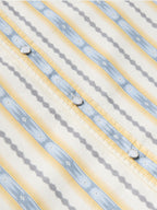 Cotton snap shirt front placket close-up with light blue and white vertical stripes