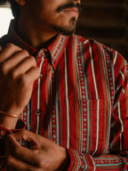 Men's striped button-down shirt close-up with red, teal, and green geometric trim