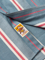 Western snap shirt close-up of branded neck label and red/white striped fabric trim