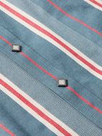 Western snap shirt close-up: light blue fabric with red and white stripe details
