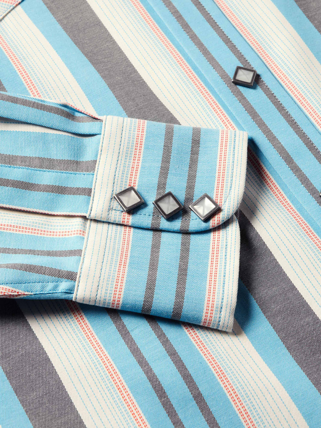 Light blue striped western snap shirt detail of flap pockets and metal-look snaps