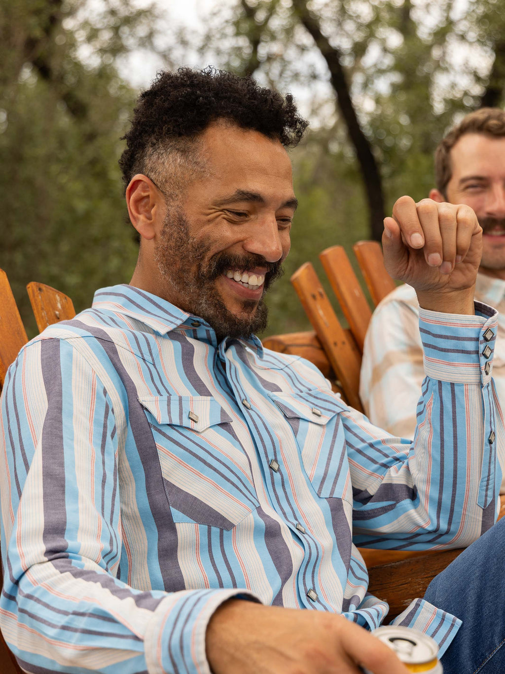Light blue striped western snap shirt worn outdoors with long sleeves