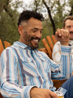 Light blue striped western snap shirt worn outdoors with long sleeves
