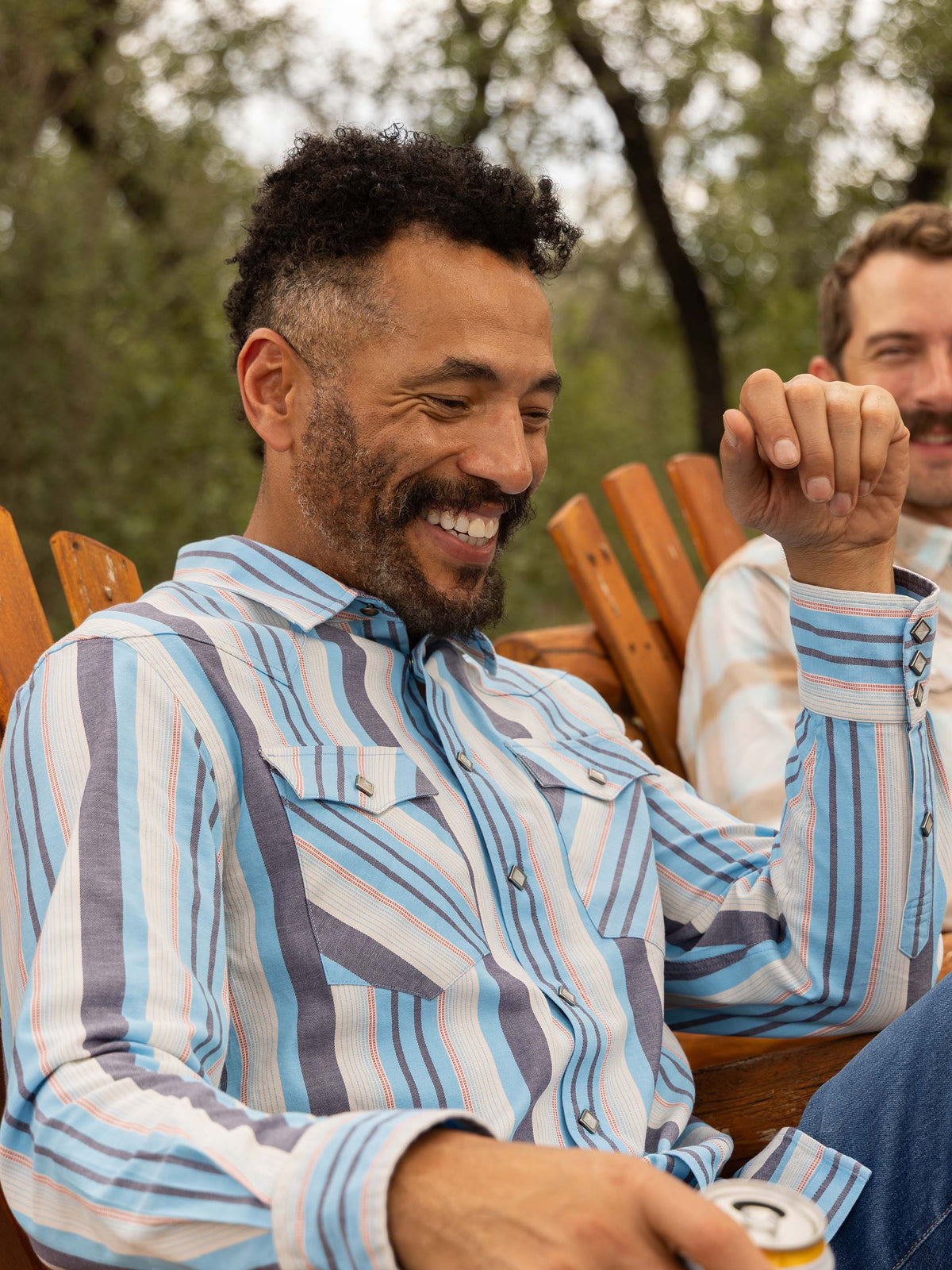 Light blue striped western snap shirt worn outdoors with long sleeves