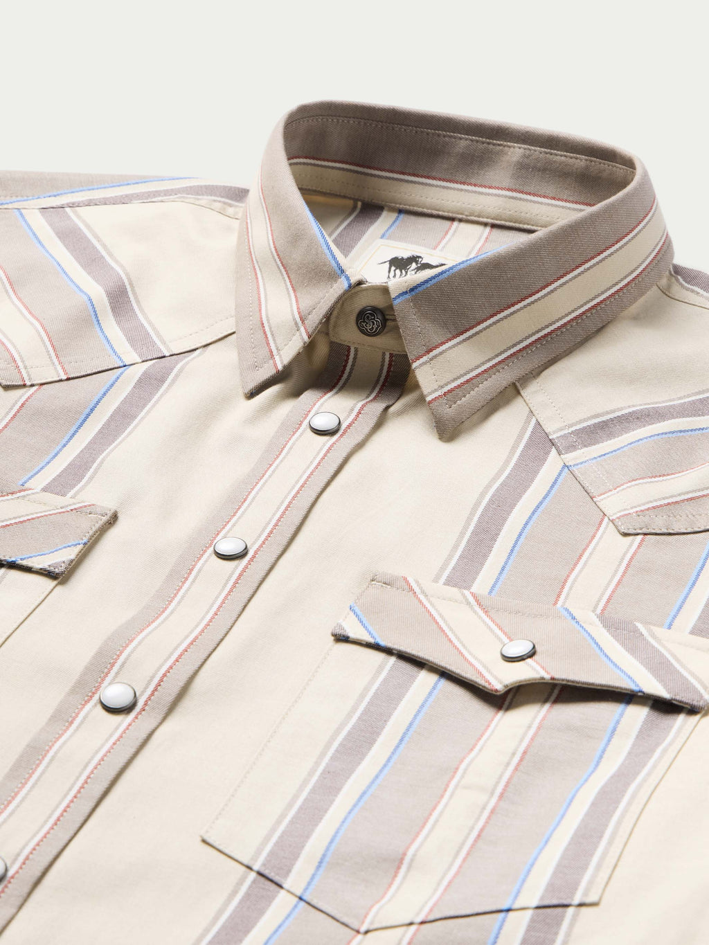 Western snap shirt in tan with blue and red stripes, button front and collar detail