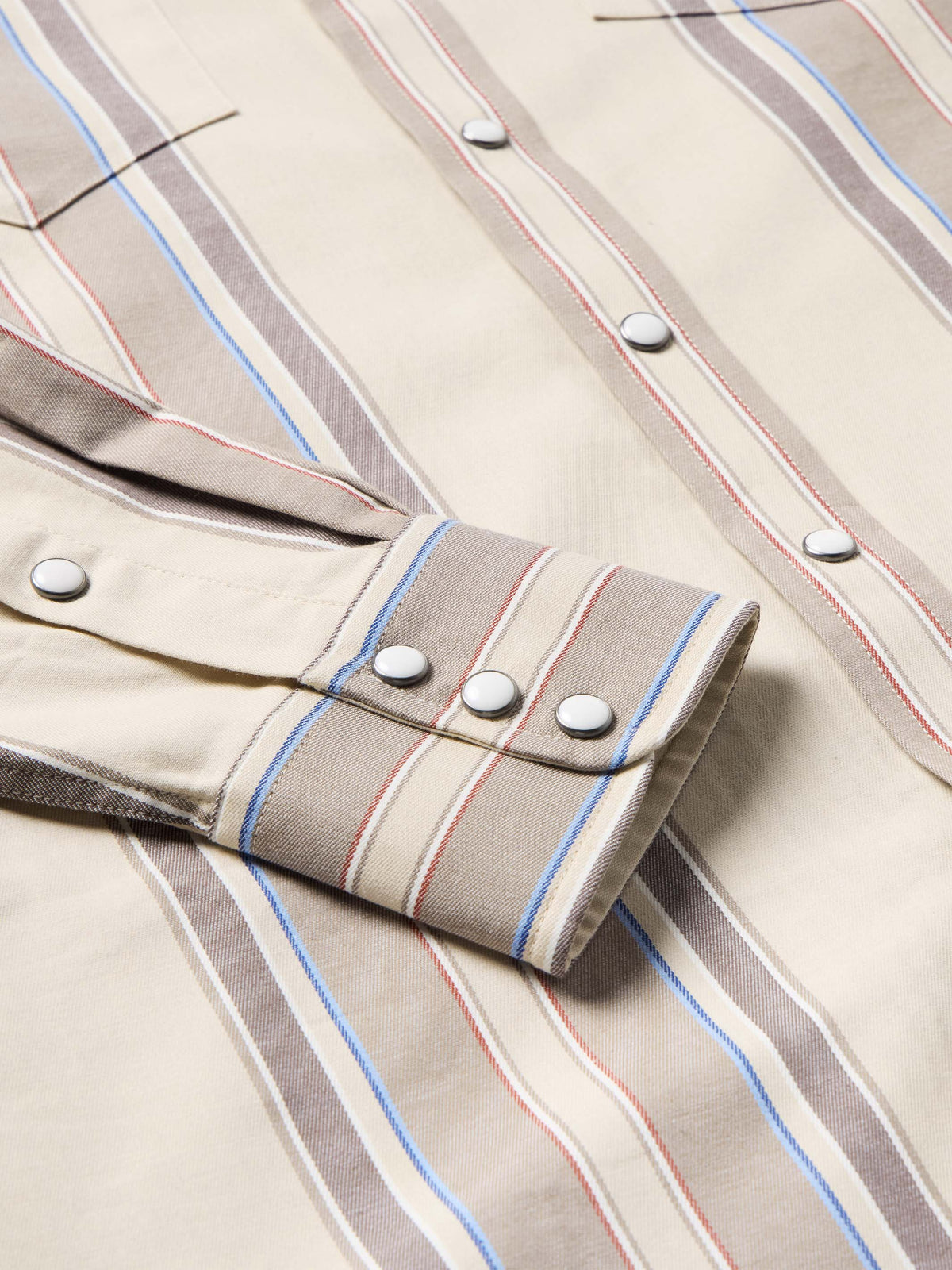 Western snap shirt in tan with blue and red vertical stripes, cuff snap detail