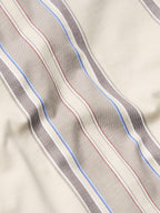 Tan western snap shirt fabric with blue, red, and gray vertical stripe pattern