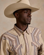 Beige western snap shirt close-up with button placket and striped yoke