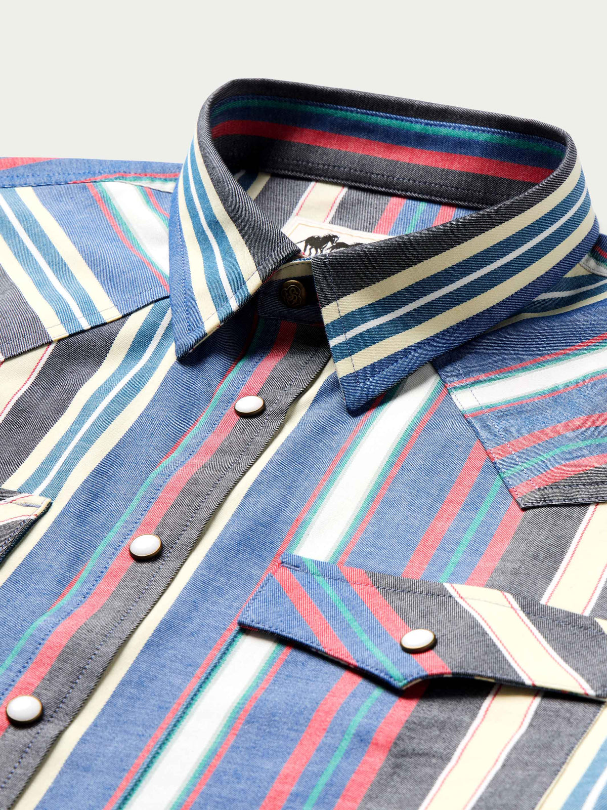 Western snap shirt close-up: striped collar, black snap placket, contrast snap buttons