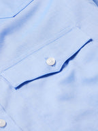 Light blue pinpoint button-down shirt cuff with white button detail