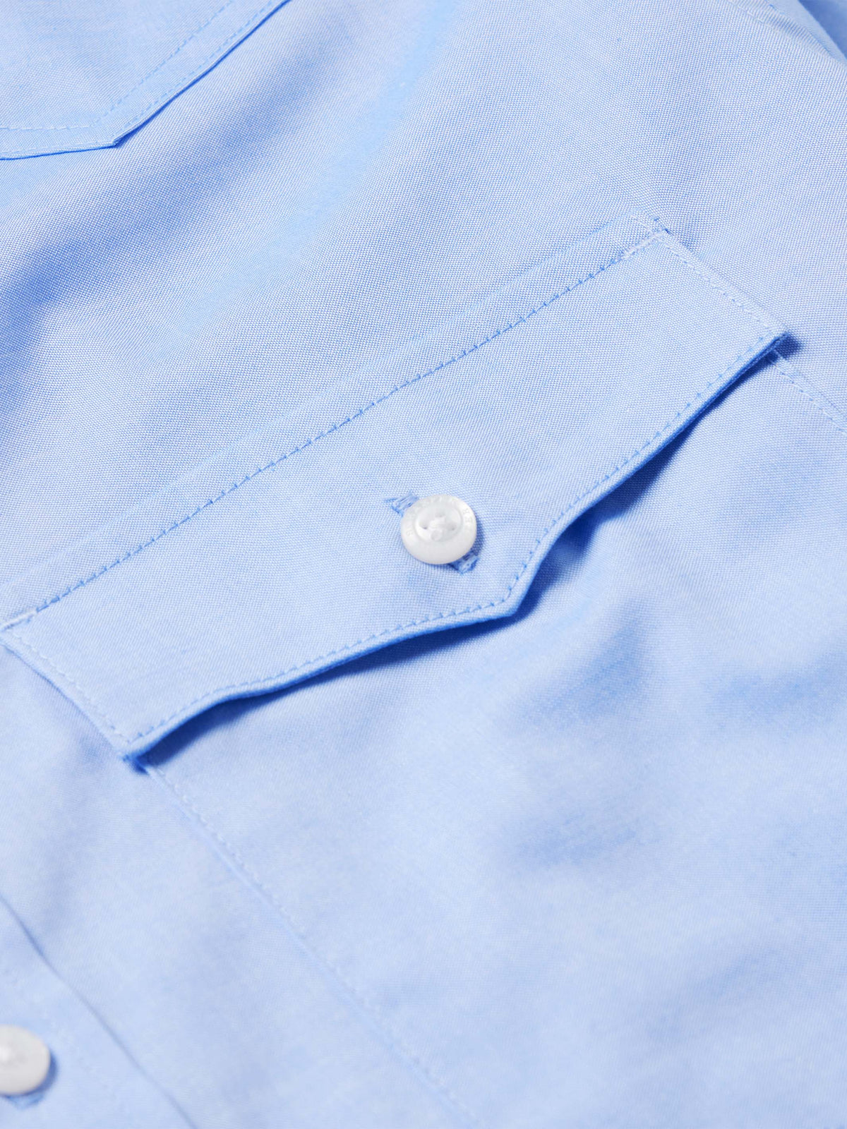 Light blue pinpoint button-down shirt cuff with white button detail