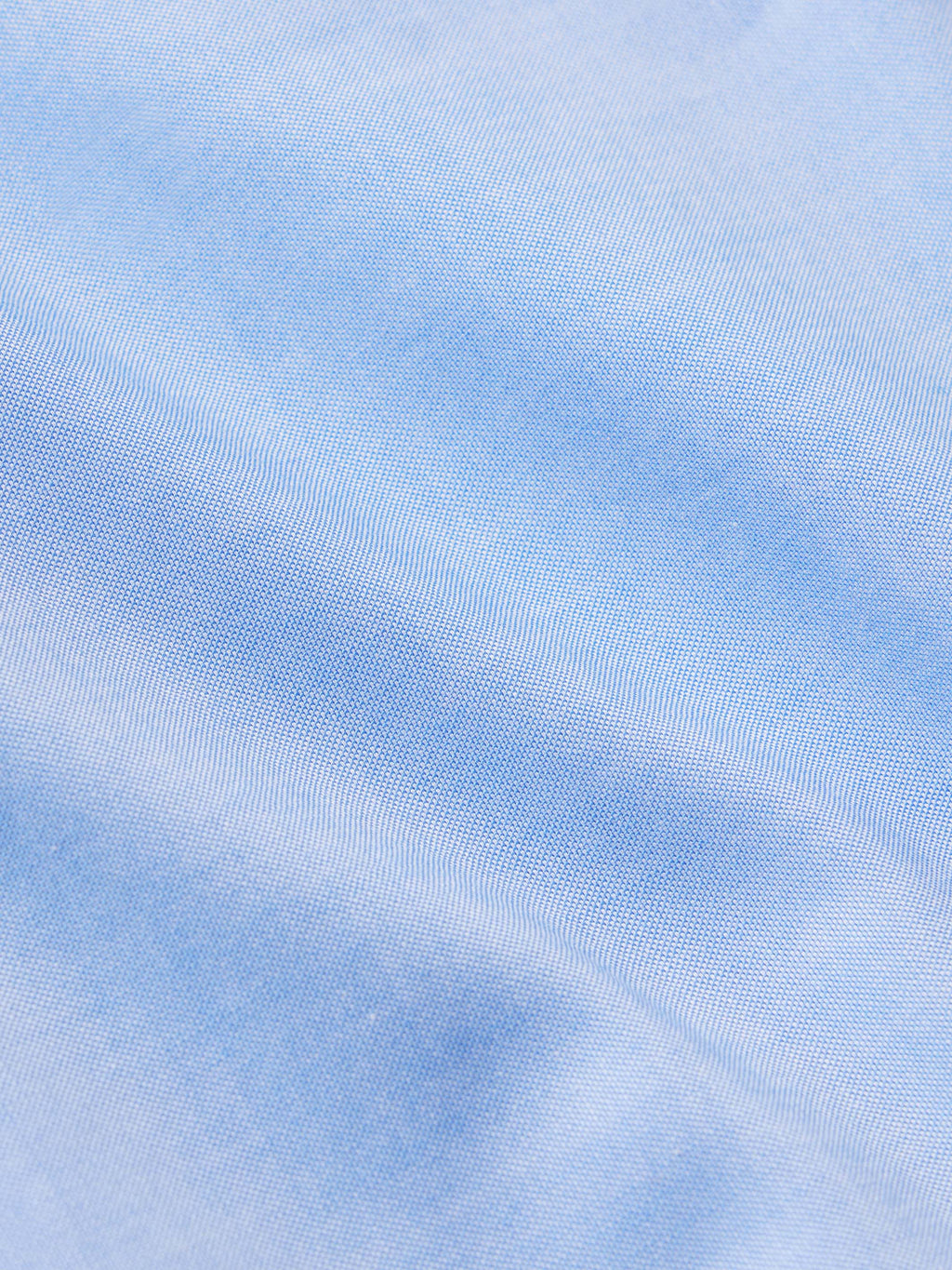 Light blue pinpoint dress shirt fabric texture close-up