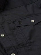 Black western snap shirt close-up of chest pocket flap and embroidered patch detail
