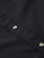 Black western snap shirt close-up of front yoke seam with two metal snaps