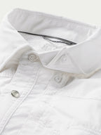 White snap shirt collar and placket detail with metal snap buttons close-up