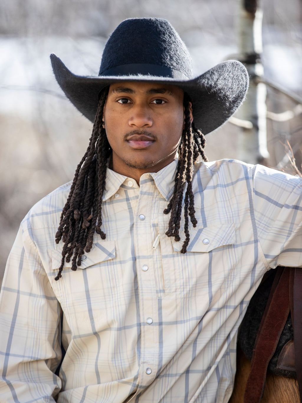 Western guide snap shirt on model, cream with blue plaid, snap buttons, point collar.