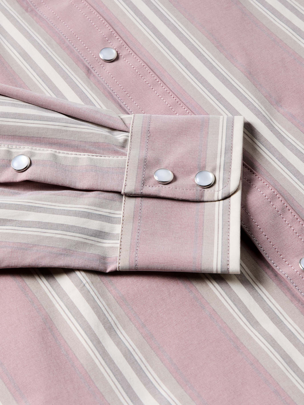 Pink striped shirt cuff and button detail with long sleeves