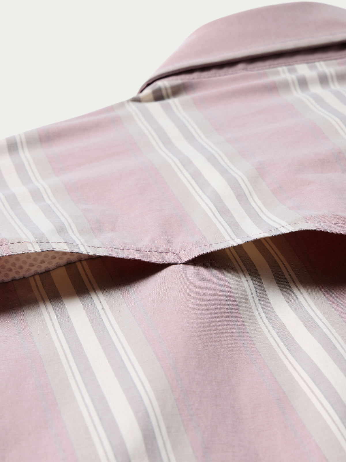 Pink striped shirt sleeve and shoulder seam close-up