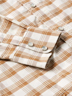 Tan-and-white plaid western snap shirt sleeves with metal snaps on cuffs.