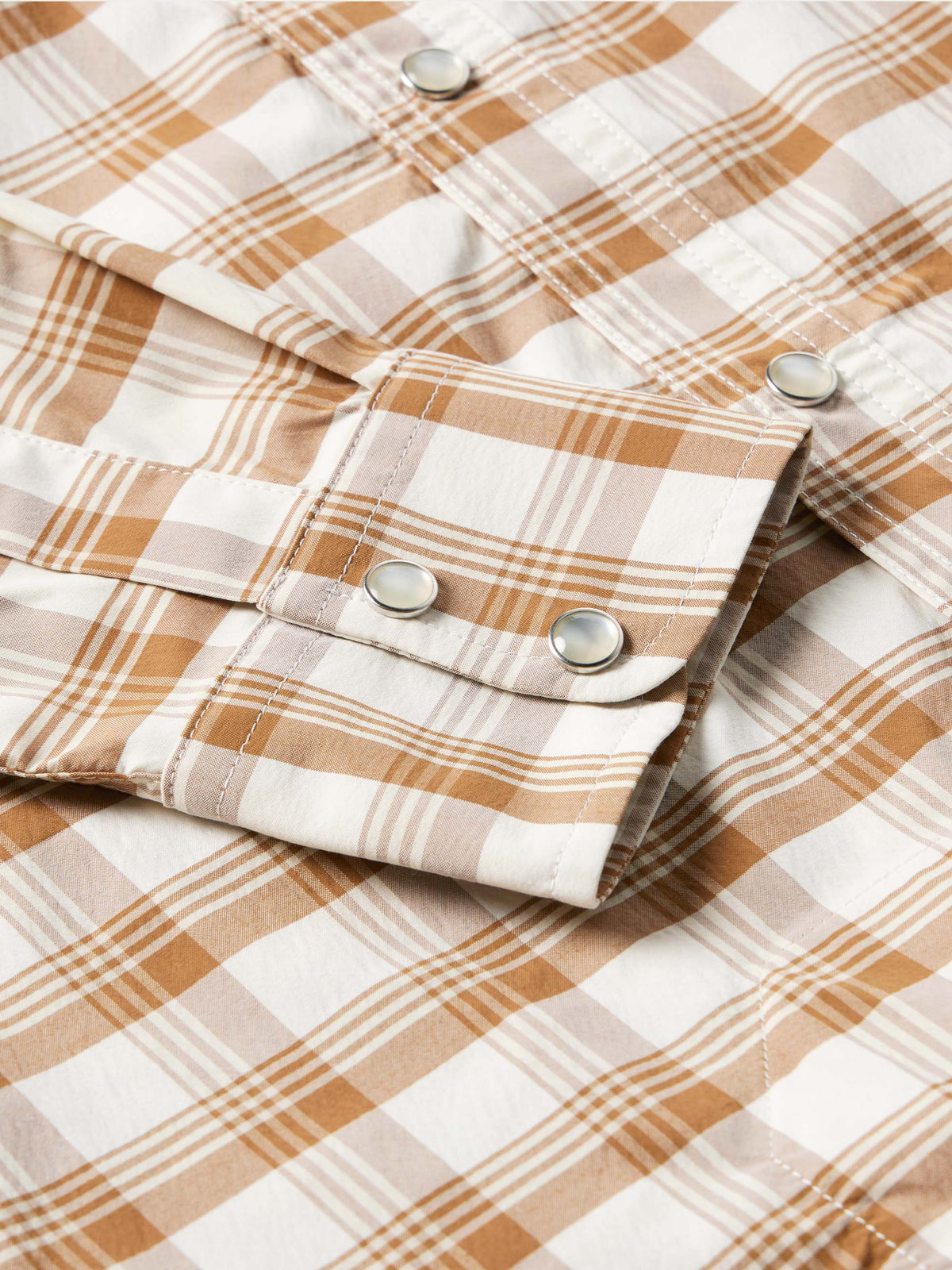 Tan-and-white plaid western snap shirt sleeves with metal snaps on cuffs.