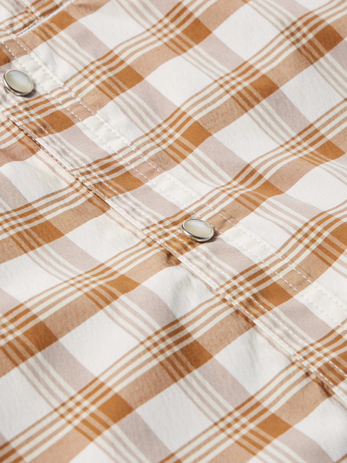 Tan-and-white plaid western snap shirt with metal snap at cuff, long sleeve.