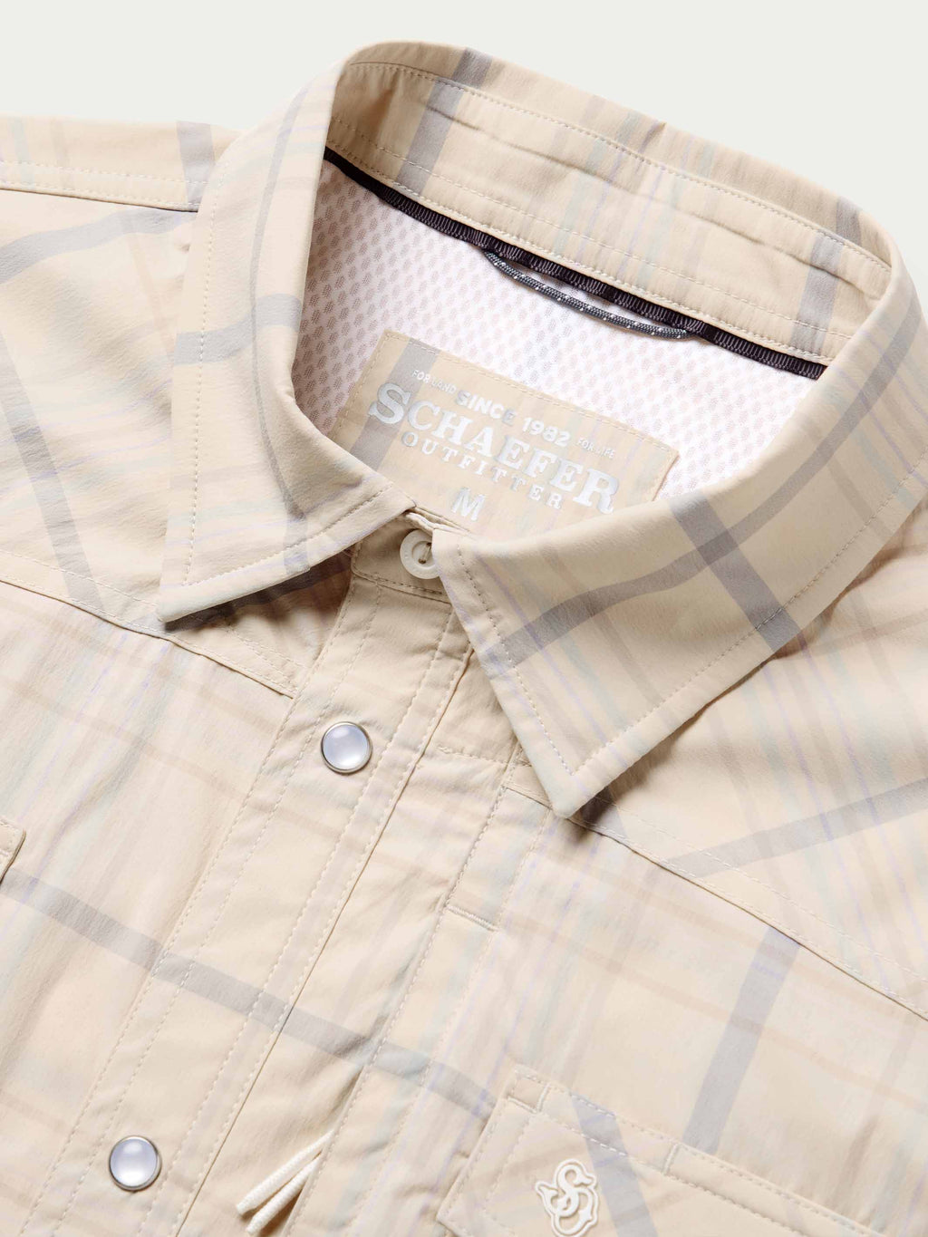 Snap shirt neckline detail, cream with blue plaid, snap collar and inner brand tag.