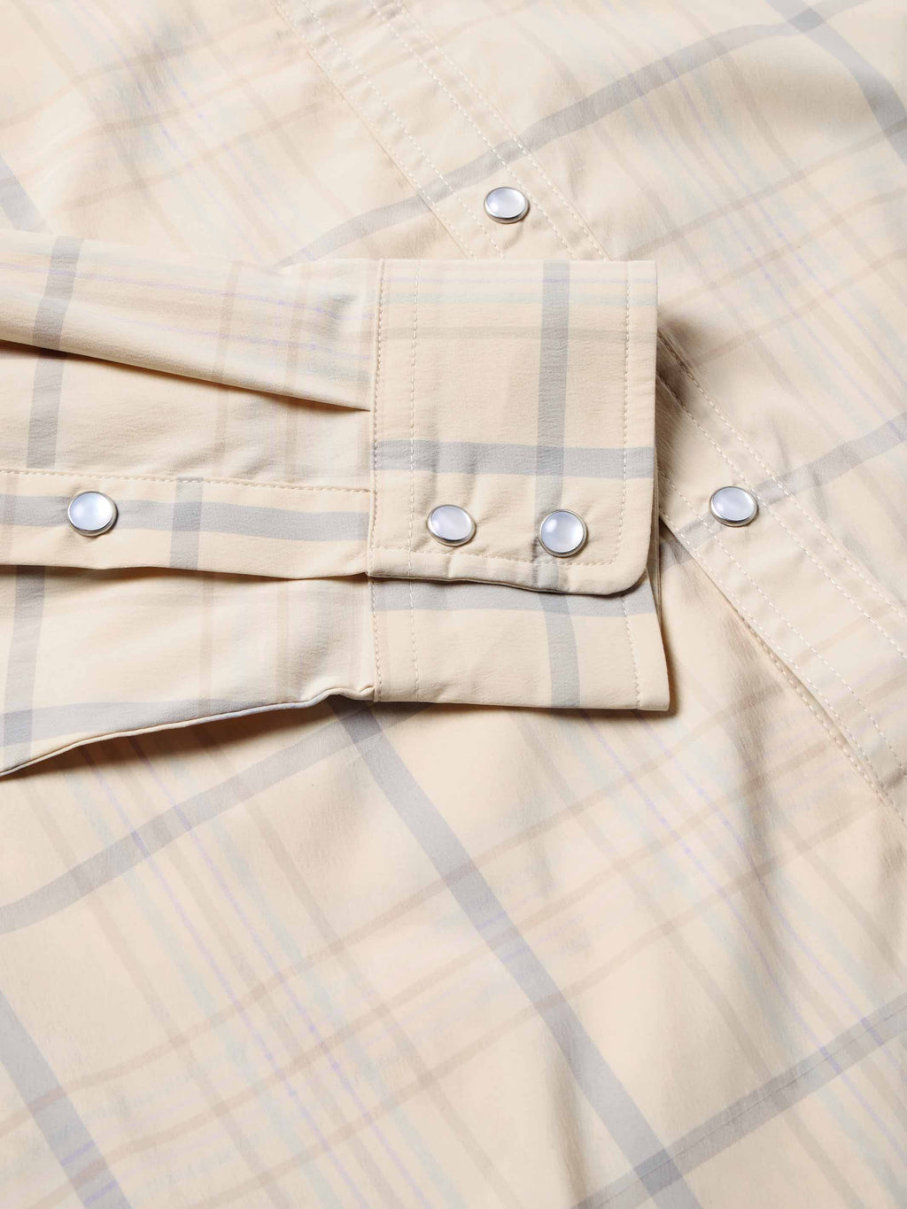Snap shirt pocket and front placket detail, cream with blue plaid, snap tabs and buttons.