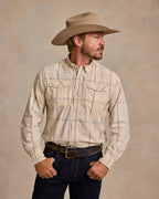 Tan plaid western snap shirt, chest pocket area and snap-front buttons