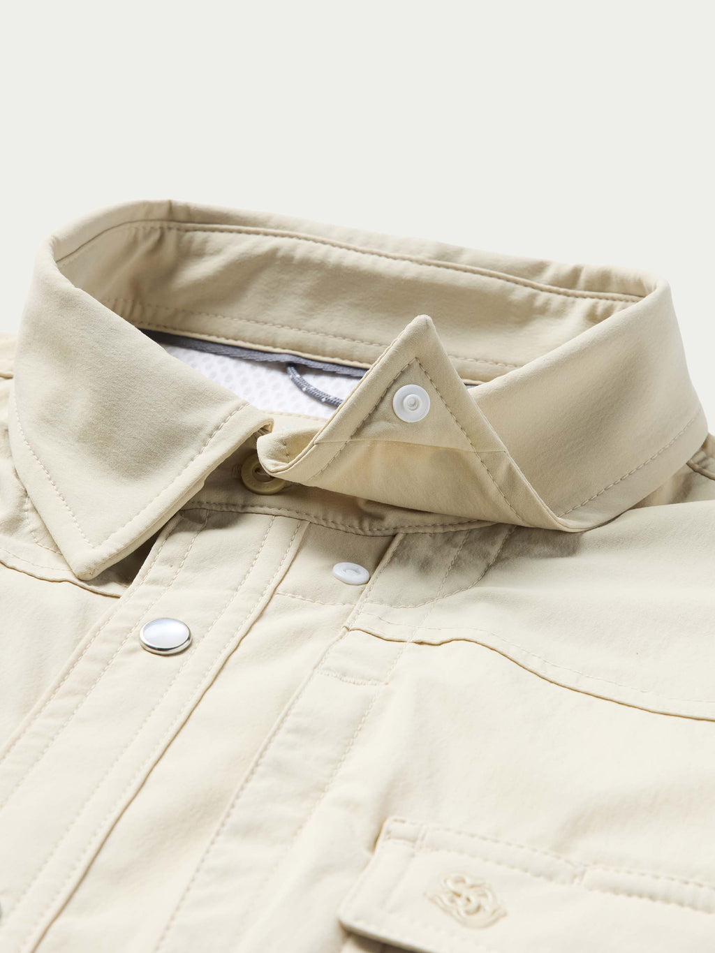 Khaki snap-front Western shirt collar and placket with metallic buttons